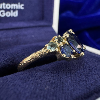 14k Yellow Gold Claw-prongs-set 0.90ct 7x5.1mm Oval Blue Sapphire w/ Round Blue/Purple/Teal Sapphires Cluster on 2mm Curvy Band Custom Ring 