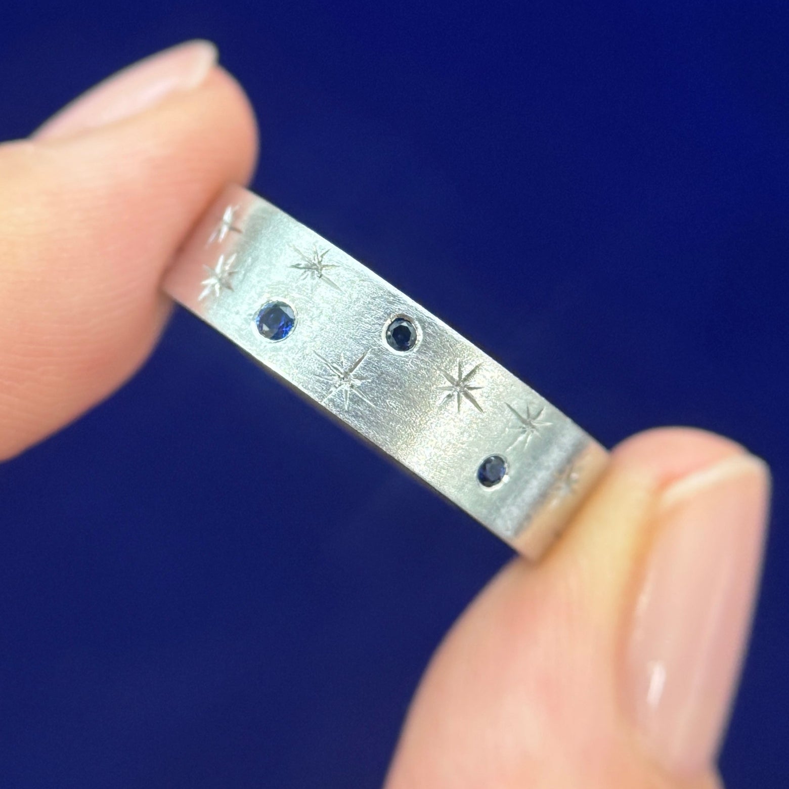 14k White Gold and Round Blue Lab Sapphires with Engraved Stars on 6mm Industrial Brushed Band Custom Ring, size 9.5