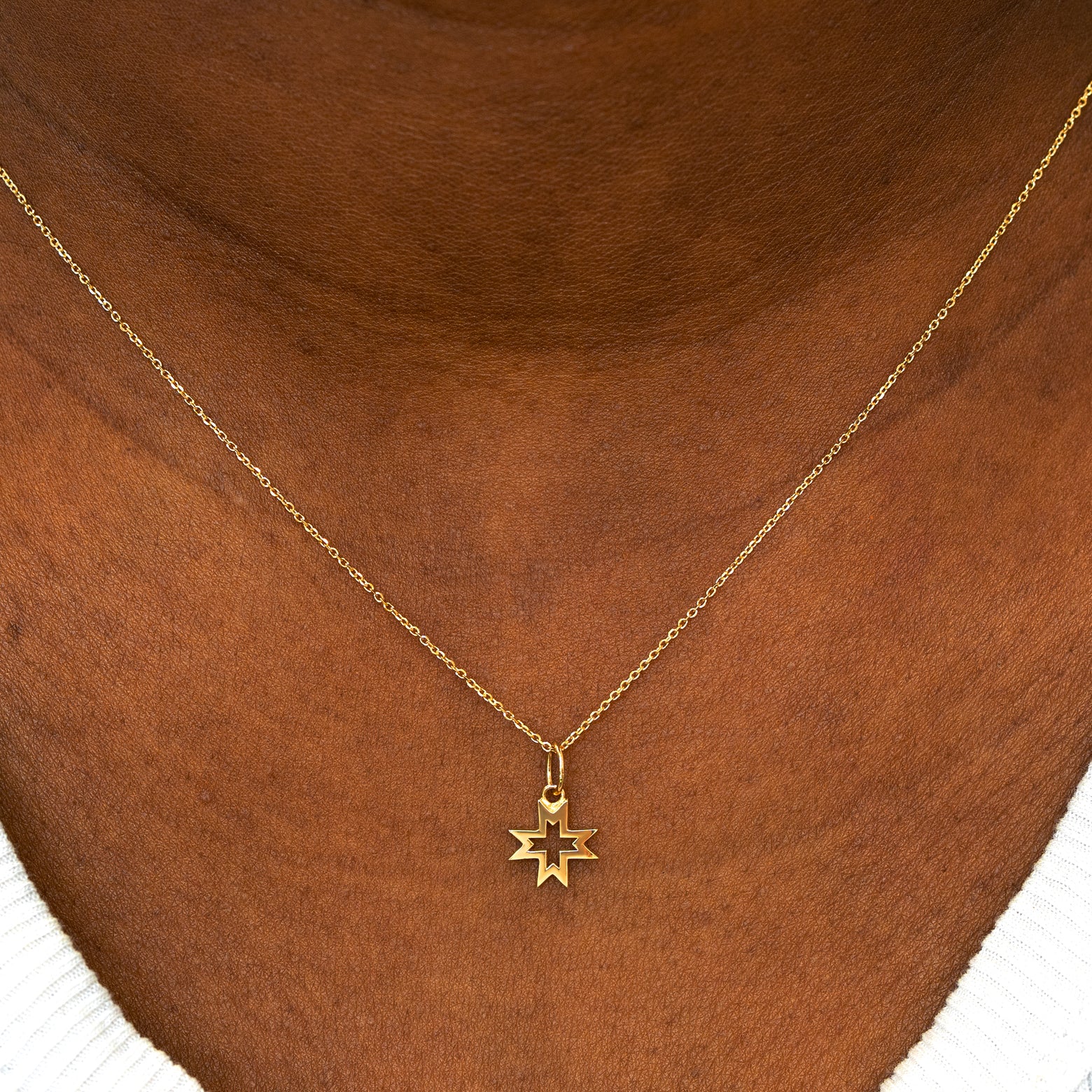 A model wearing a Large Open 8 Pointed Star Charm on a Cable Chain Necklace