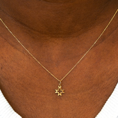 A model wearing a Large Open 8 Pointed Star Charm on a Cable Chain Necklace