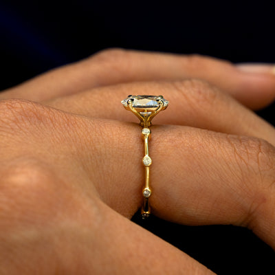 Side view of an Oval Lab Diamond Bubble Ring on a model's finger to show the height of the stone
