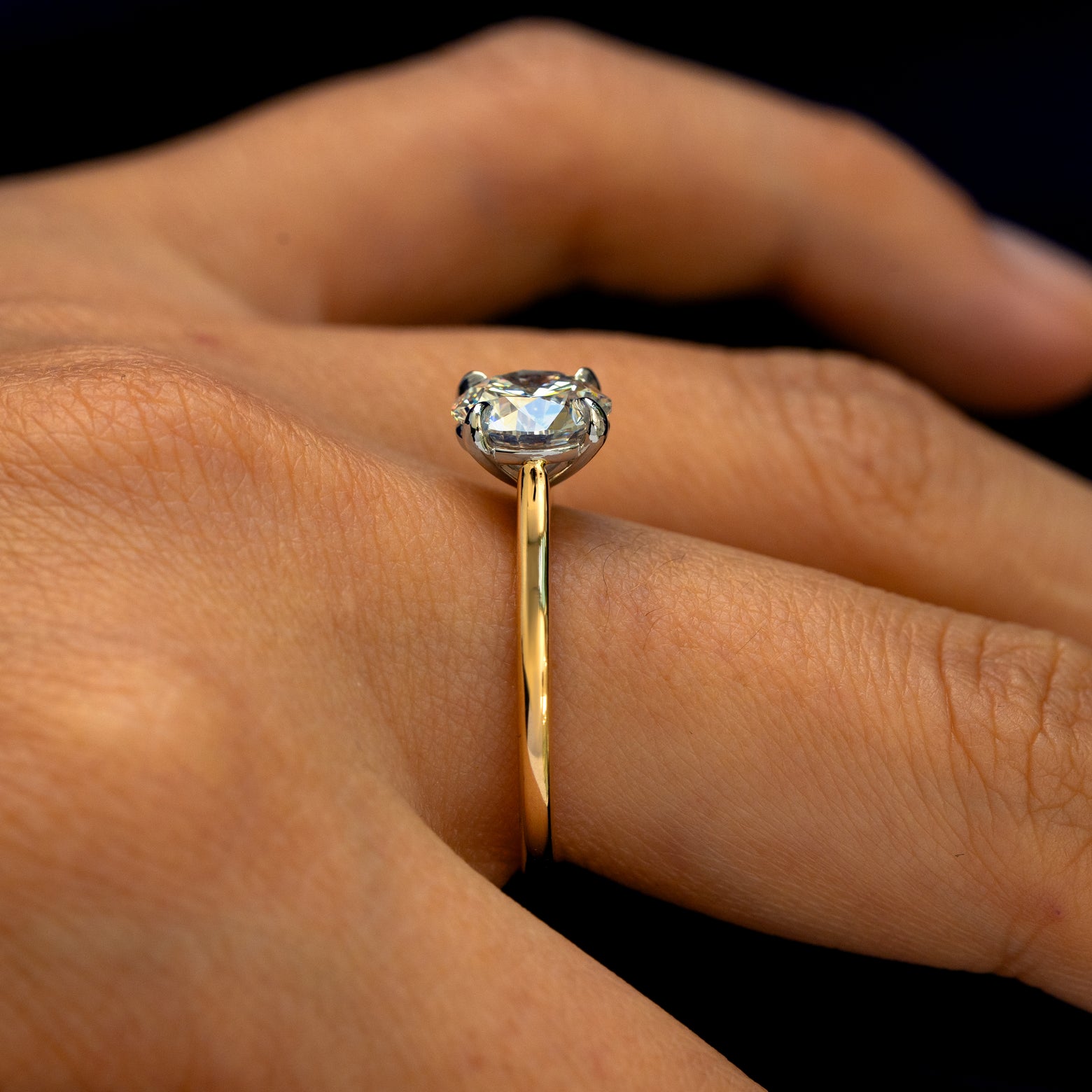 Side view of a Round Lab Diamond Cathedral Set Ring on a model's finger to show the height of the stone