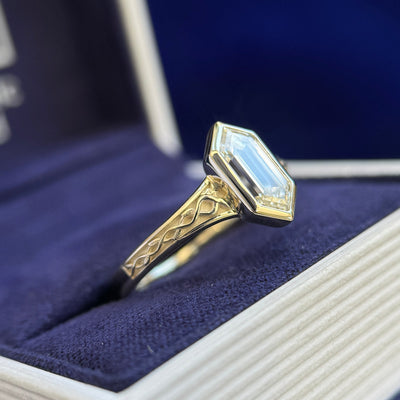 side view of 14k Champagne Gold and Bezel-set 1.4ct Elongated Hexagon Lab Diamond on Seraphine-style Celtic Engravings with Leaves Band Half-way Around the Band Custom Ring, Size 8