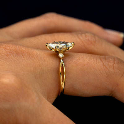 Side view of a Marquise Lab Diamond Three Stone Ring on a model's finger to show the detailing on the side