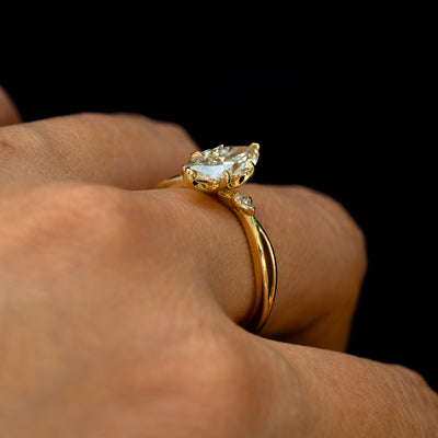 Angled view of a Marquise Lab Diamond Three Stone Ring on a model's finger to show the height of the stone
