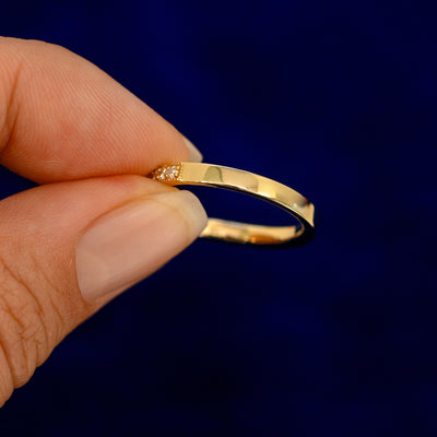 A model holding a Milgrain Pave Diamond Chevron Band backward to show the details of the back of the band