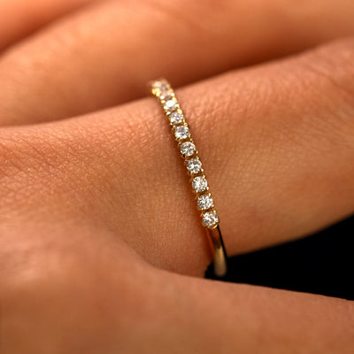 Side view of a Mini Petal Set Diamond Eternity Band on a model's finger