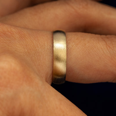 Side view of a 14 karat solid gold Mix Matte Band on a model's finger