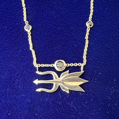 close up of necklace in with cut out pendant