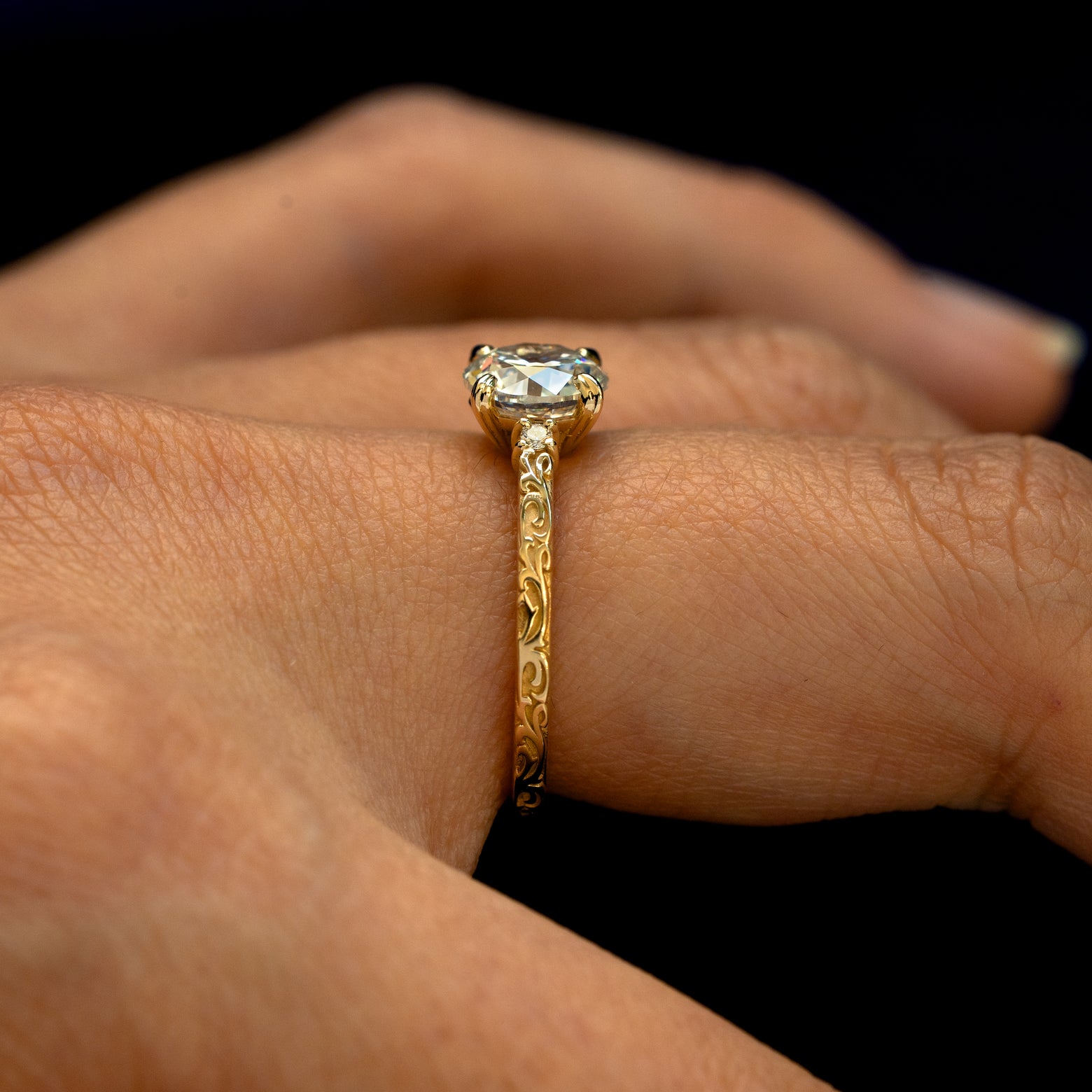 Side view of an Old Mine Cut Lab Diamond Filigree Ring on a model's finger to show the filigree details on the band