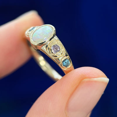 14k Yellow Gold Bezel-set 0.49ct Oval Australian Opal with 4pc Pink and Blue Sapphires inside Rose Engravings on Custom Tapered Band, size 7.5
