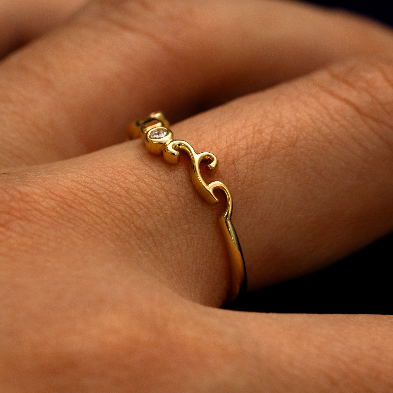 Side view of an Open Filigree Chevron Diamond Band on a model's finger