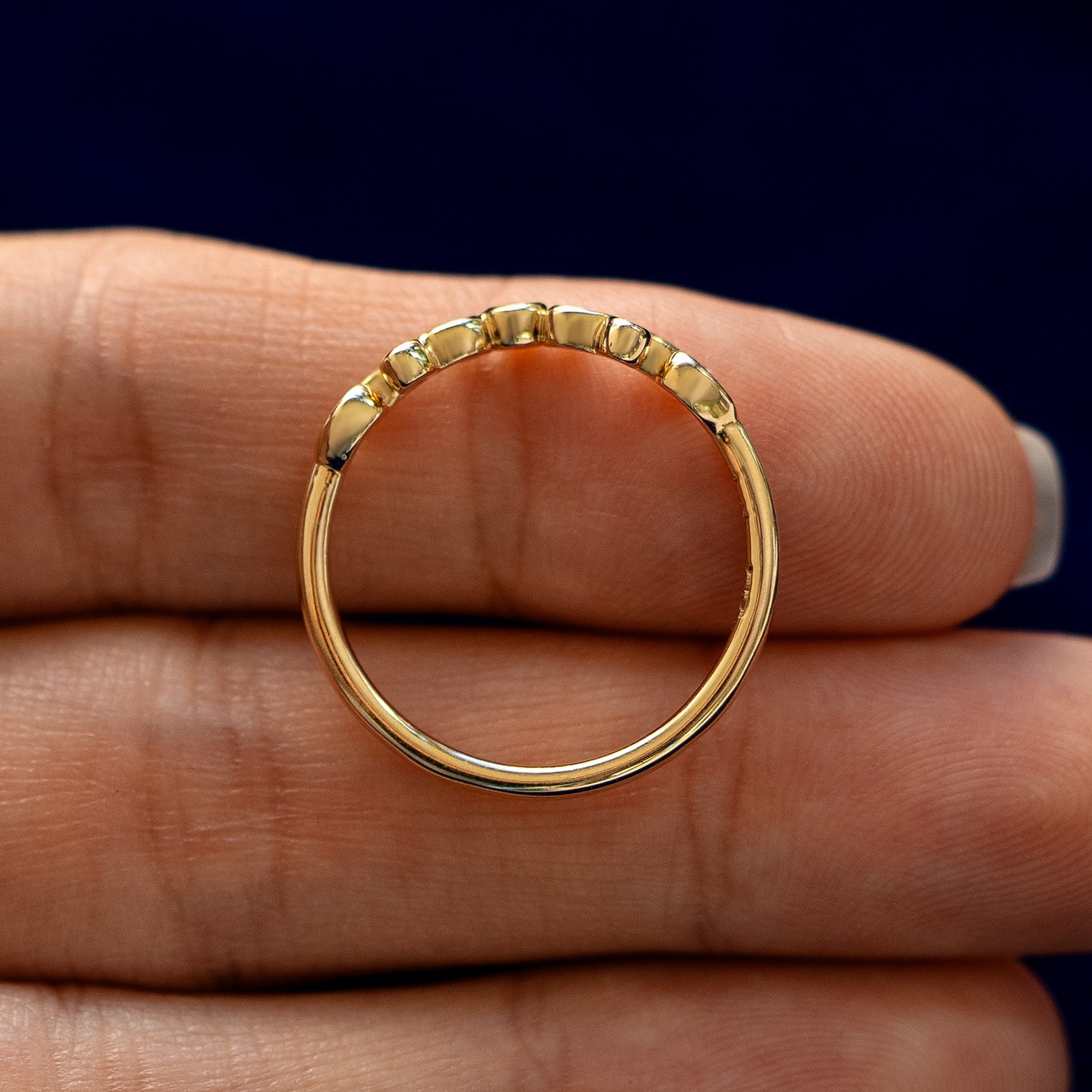 An Open Filigree Chevron Diamond Band lying flat in a models hand to show the thickness of the Ring