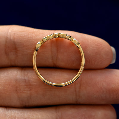 An Open Filigree Chevron Diamond Band lying flat in a models hand to show the thickness of the Ring