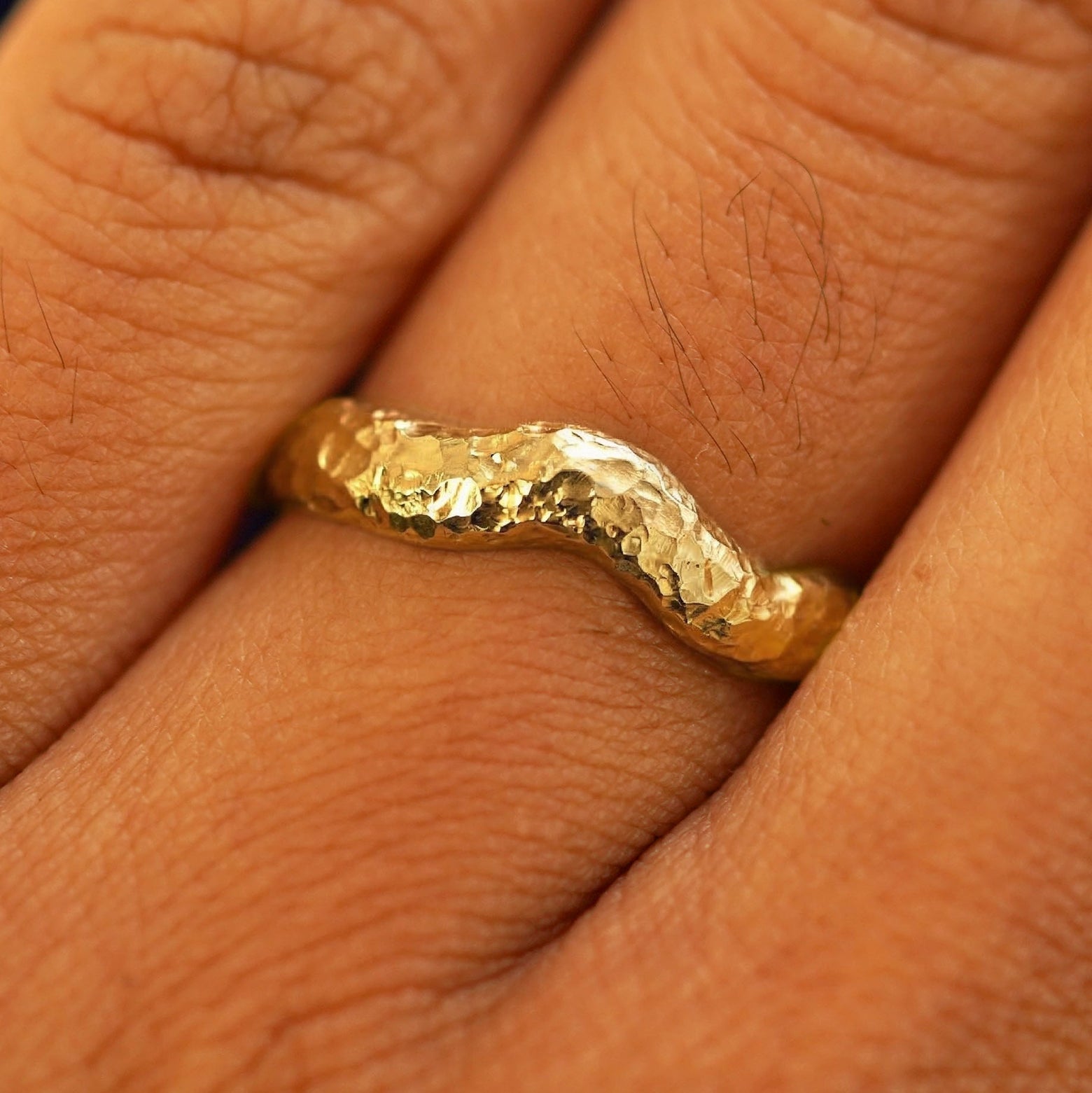 Close up view of a model's fingers wearing a 14k Organic Liquid Band