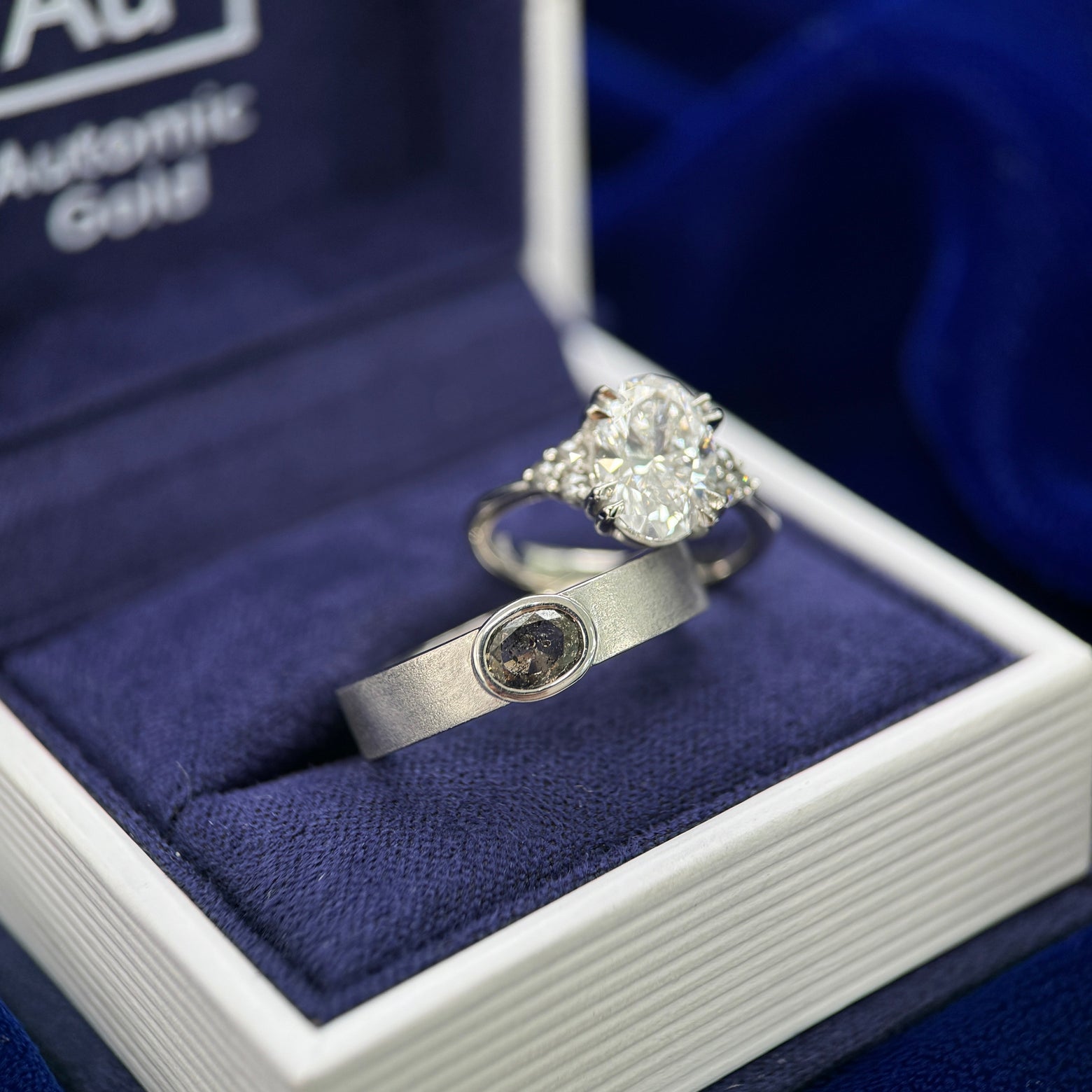 950 Platinum & 1.5ct Oval Lab Diamond & 0.14ct Salt-and-pepper Diamonds Tappered 1-2.5mm Band Custom Ring & 950 Platinum & Bezel-sideways-set 0.40ct Oval Salt-and-pepper Diamond on 4mm Industrial Matte Band