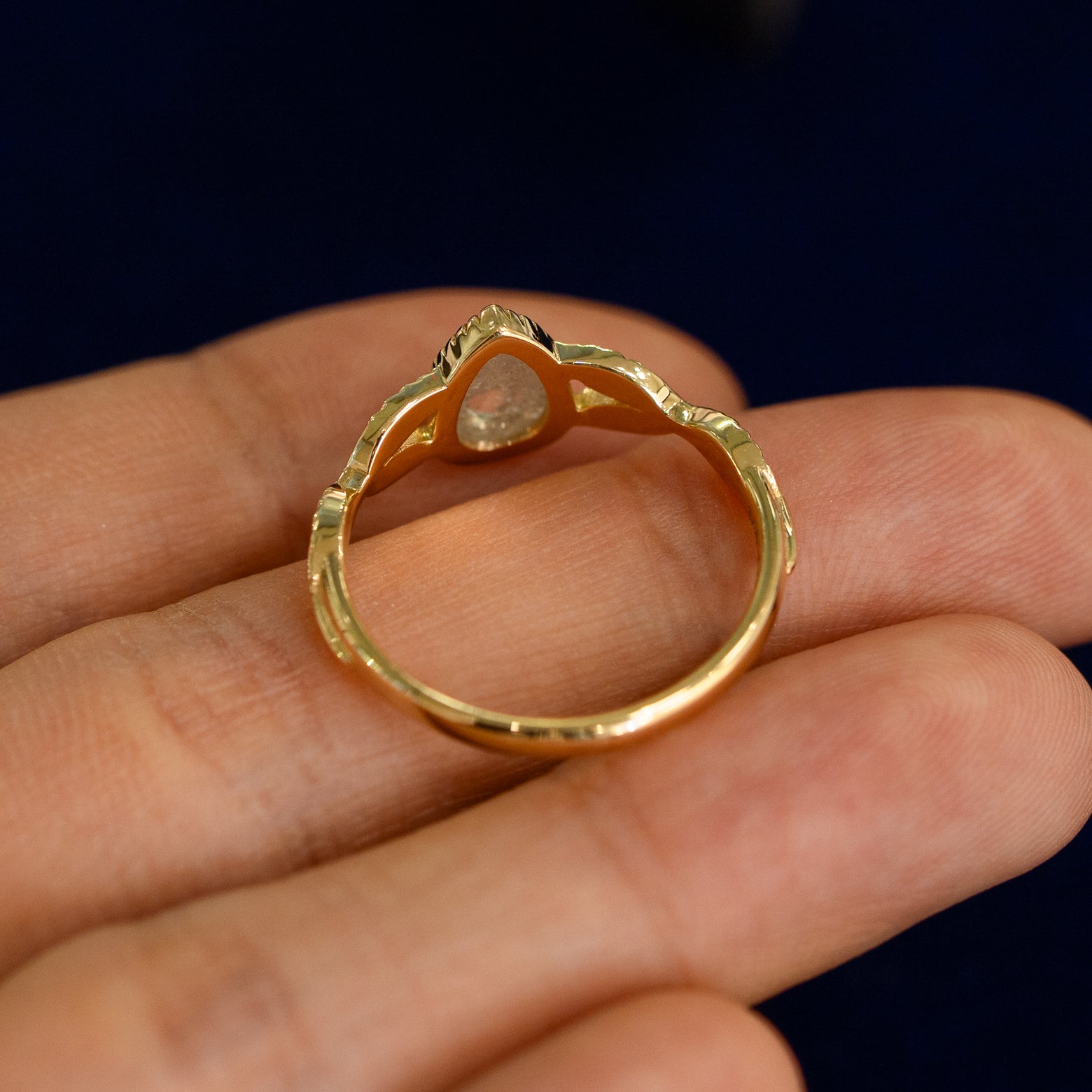 Underside view of a solid 14k gold Pear Salt and Pepper Diamond Leaves Ring