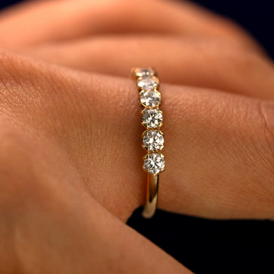 Side view of a Petal Set Diamond Eternity Band on a model's finger