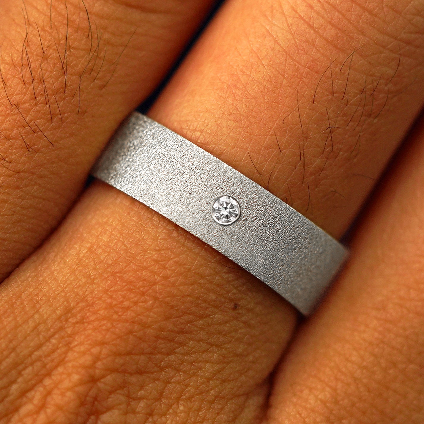 Close up view of a model's fingers wearing a Platinum Industrial Stardust Band