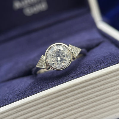 950 Platinum and Clients Round Diamond reset into 6 claws low set with two Bezel-set Triangles Diamonds on Thin to Thick Band Custom Ring, size 5