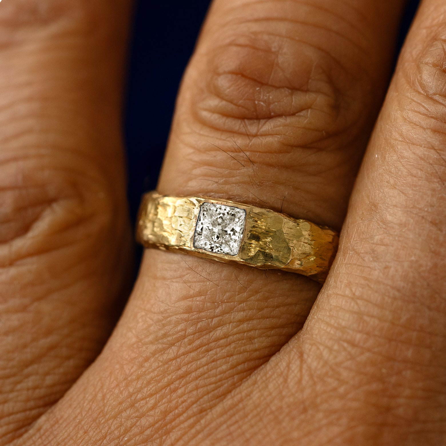 A princess cut lab diamond organic band on a models finger