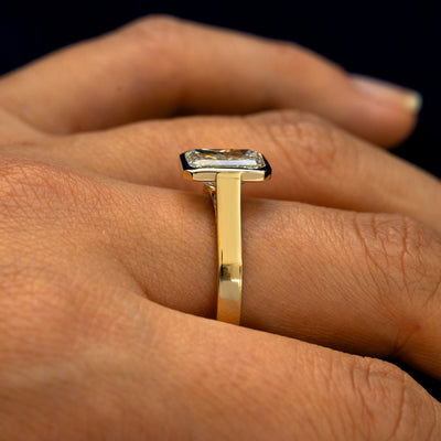 Side view of a Radiant Cut Lab Diamond Cathedral Ring on a model's finger to show the height of the stone