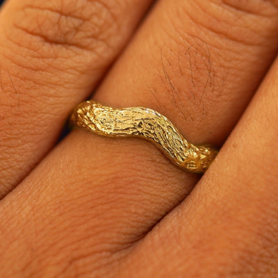 Close up view of a model's fingers wearing a 14k Raw Liquid Band