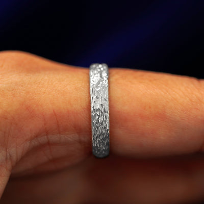 Side view of a 925 sterling silver Raw Band on a model's finger