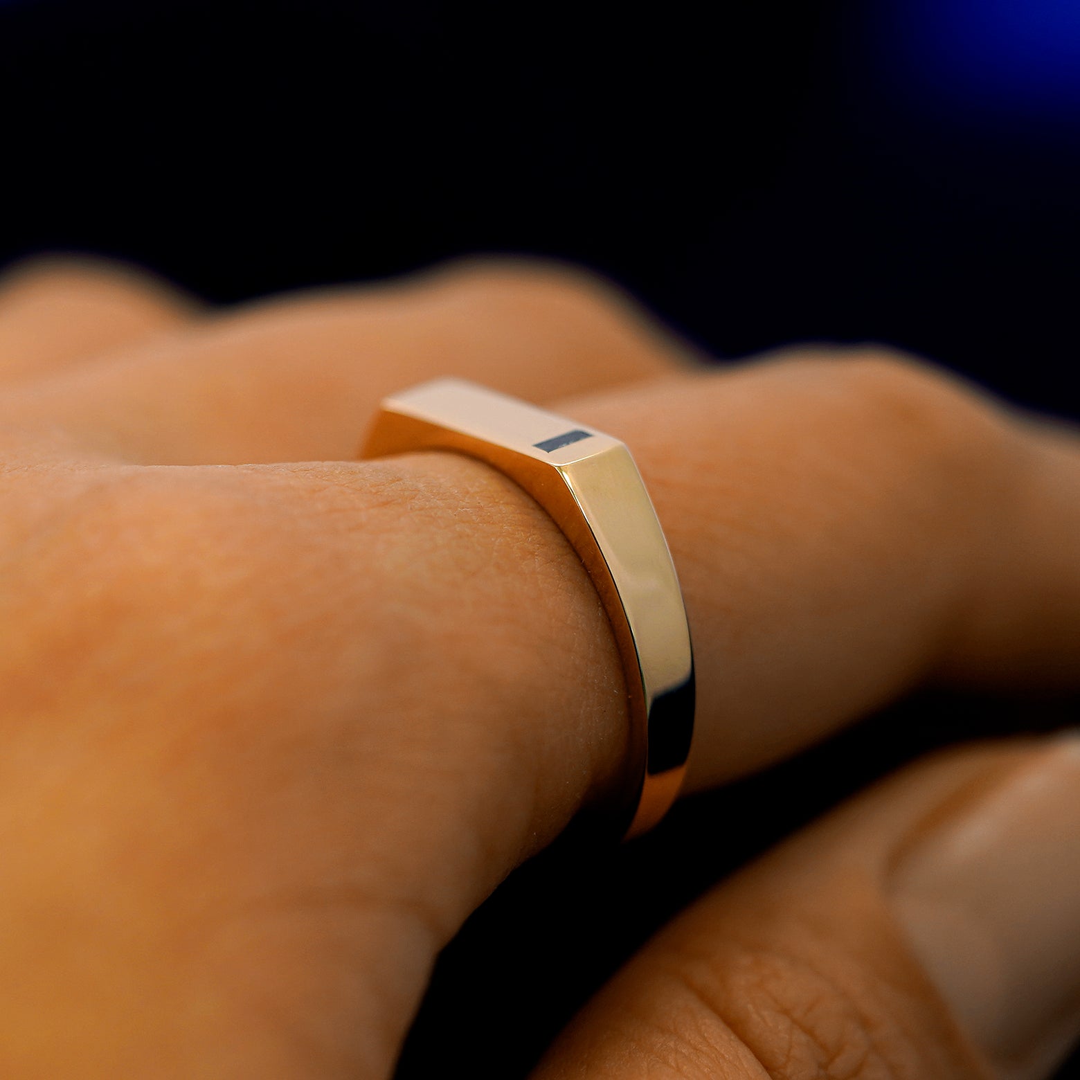 Side view of a model wearing a baguette salt and pepper diamond rectangular signet ring to show the height of the ring