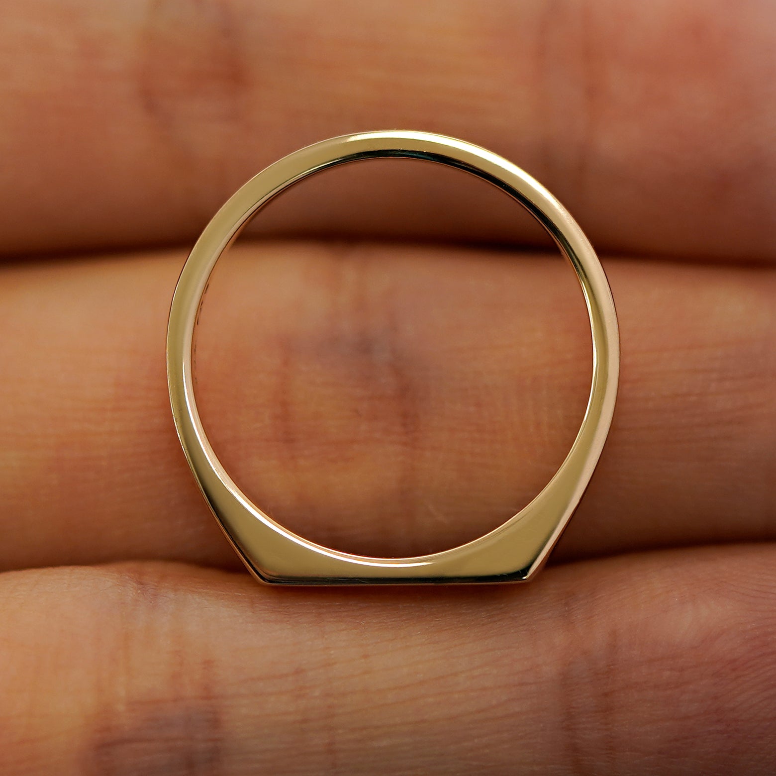 A baguette salt and pepper diamond rectangular signet ring laying flat in a models hand to show the thickness of  the band