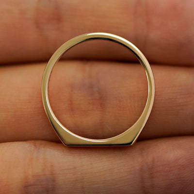 A baguette salt and pepper diamond rectangular signet ring laying flat in a models hand to show the thickness of  the band