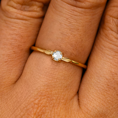 A solid 14k yellow gold Rose Cut Diamond Two Leaf Ring on a model's finger