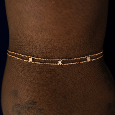 A model wearing a rose gold 8 pointed star bracelet