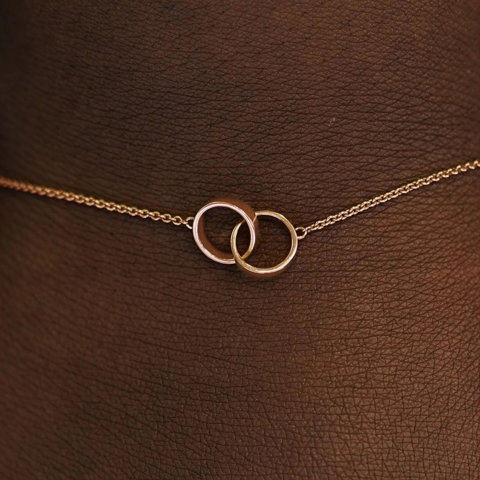 Close up view of a model's wrist wearing a  rose solid gold Bound Together Bracelet