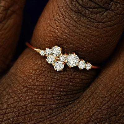 Close up view of a model's fingers wearing a 14k rose gold Diamond Cluster Ring