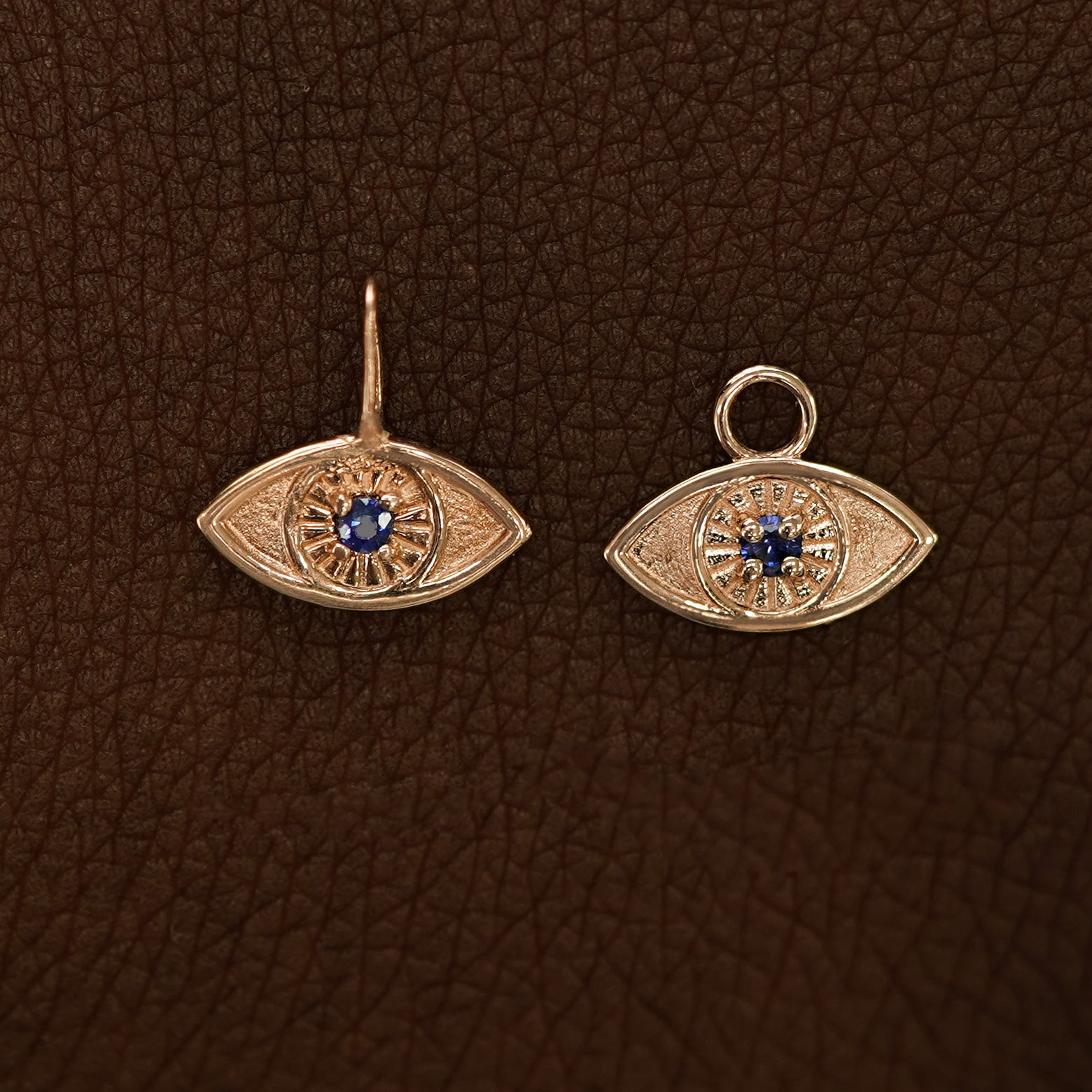 Two 14 karat Rose gold blue sapphire Evil Eye Charms shown in the For Chain and For Earring options