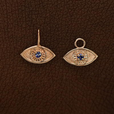Two 14 karat Rose gold blue sapphire Evil Eye Charms shown in the For Chain and For Earring options