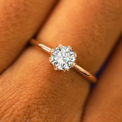 Close up view of a model's hand wearing a solid rose gold Lab Diamond Petal Ring