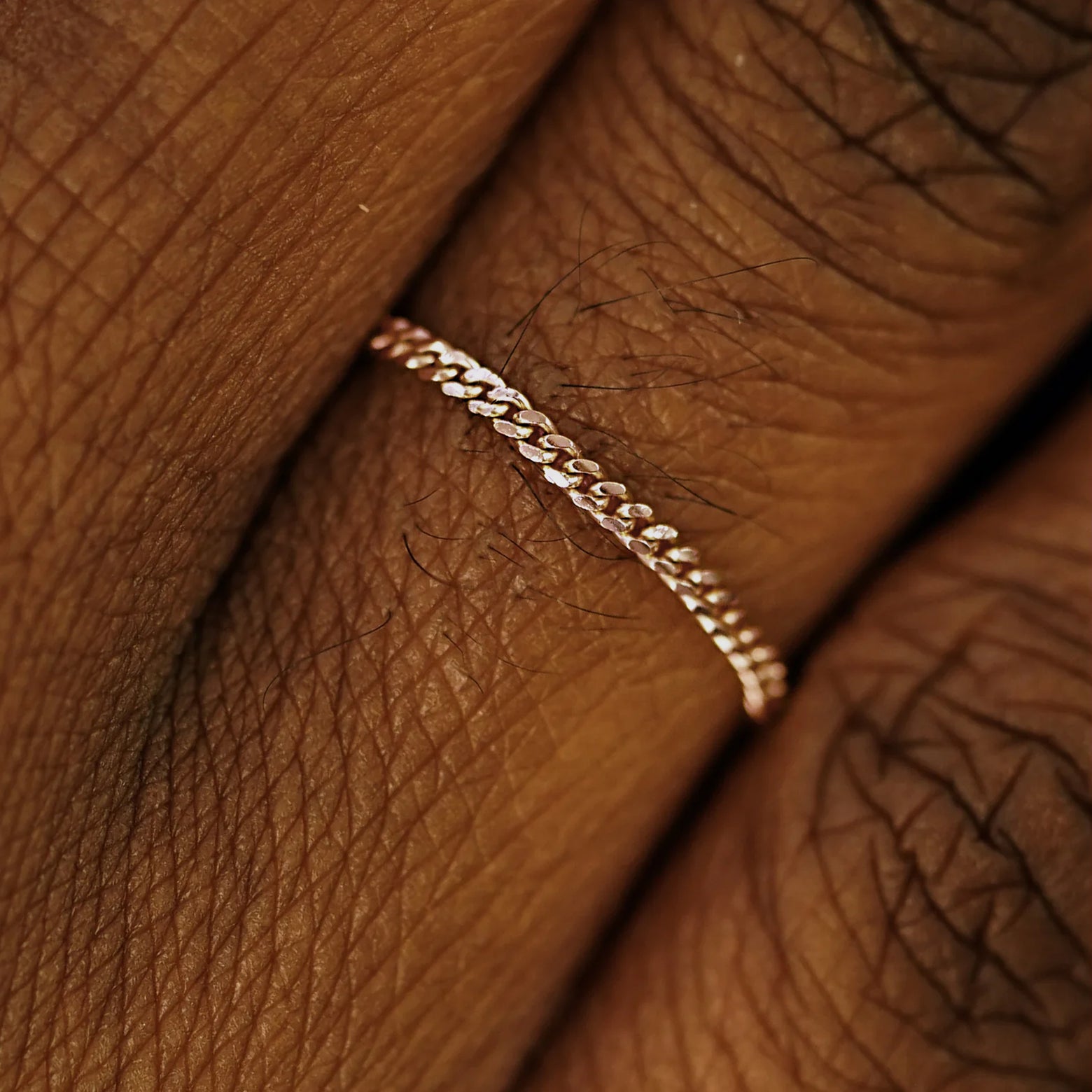 Close up view of a model's fingers wearing a 14k rose gold Mini Miami Ring