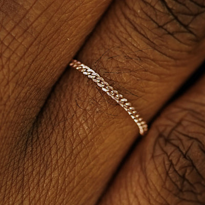 Close up view of a model's fingers wearing a 14k rose gold Mini Miami Ring