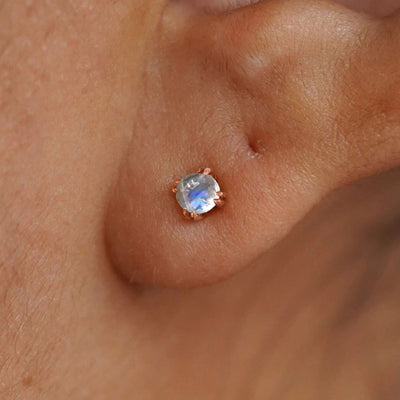 Close up view of a model's ear wearing a 14k rose gold Moonstone Earring