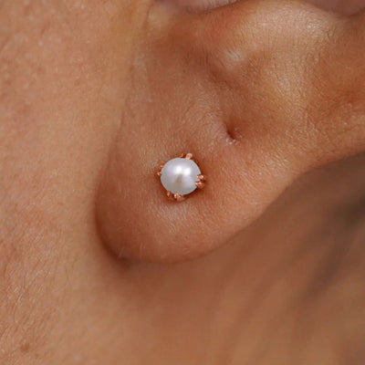 Close up view of a model's ear wearing a 14k rose gold Citrine Stud Earring