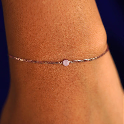 A model's wrist wearing a 14 karat rose gold Rose Quartz Bracelet
