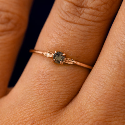 A solid 14k rose gold Smoky Quartz Gemstone Two Leaf Ring on a model's finger
