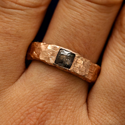 Close up view of a models fingers wearing a 14k rose gold Square Diamond Organic Band