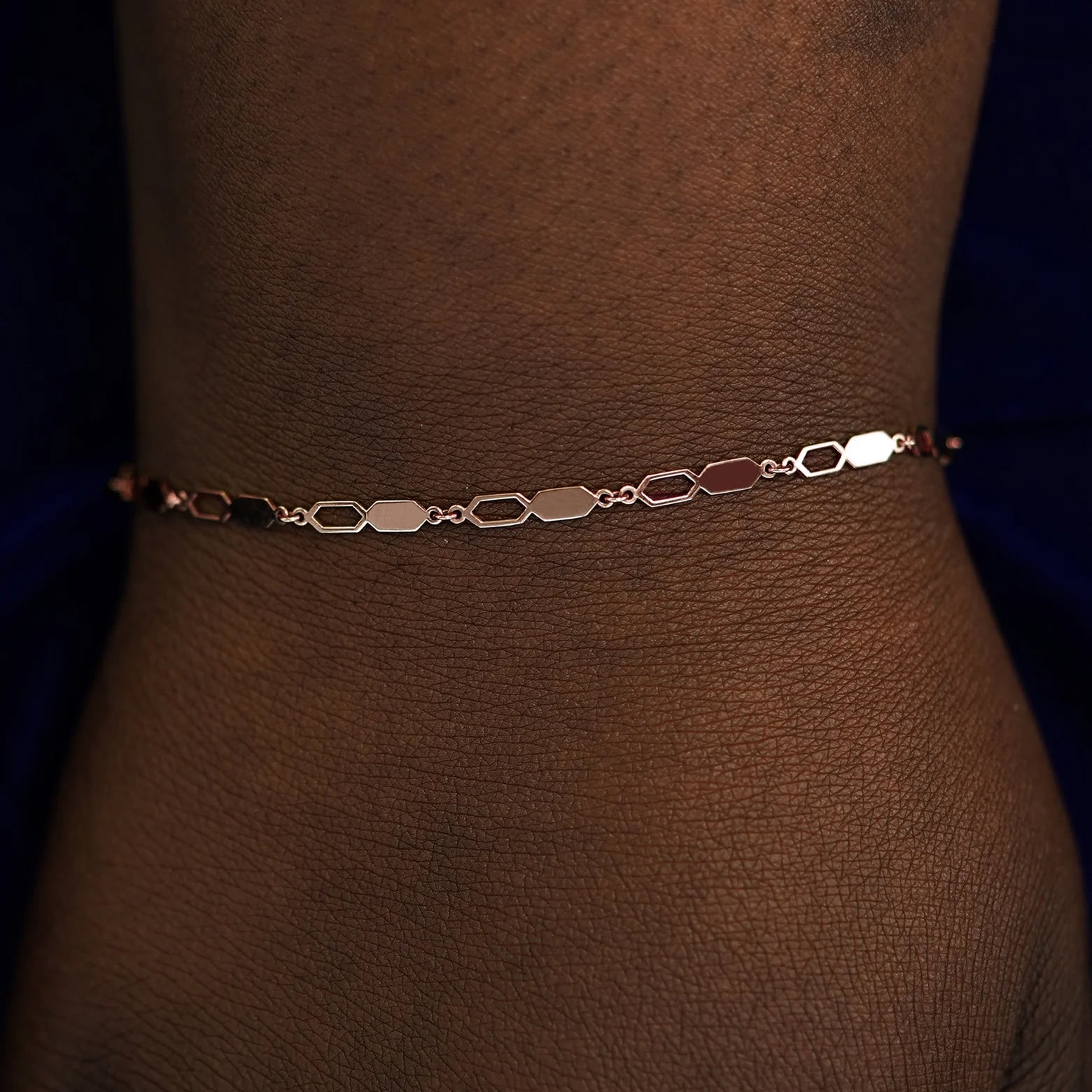 A model's wrist wearing a solid rose gold Tanlah Bracelet