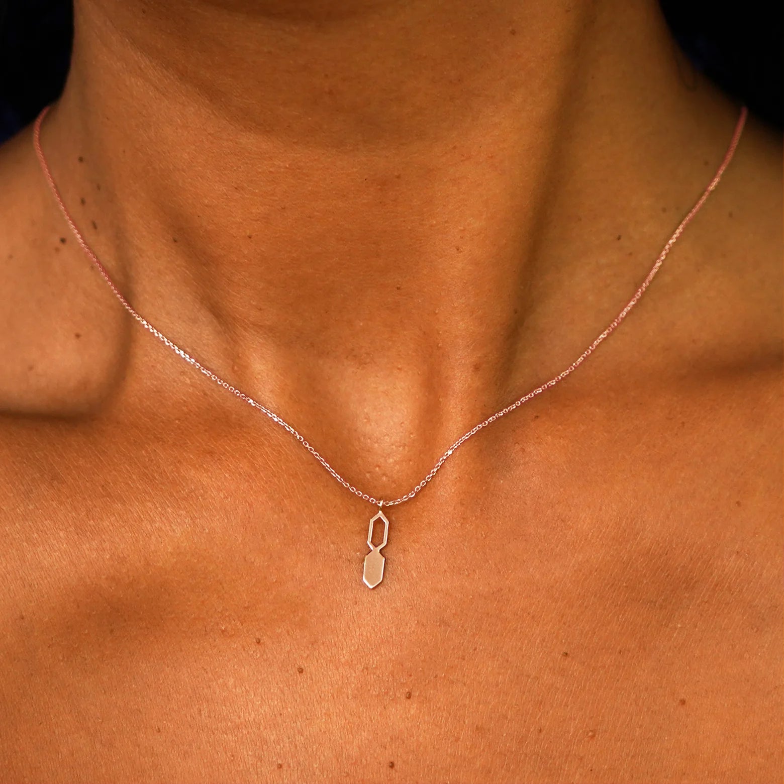 Close up view of a model's neck wearing a solid 14k rose gold Tanlah Cable Necklace
