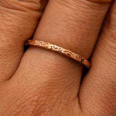 Close up view of a model's fingers wearing a 14k rose gold Thin Filigree Band