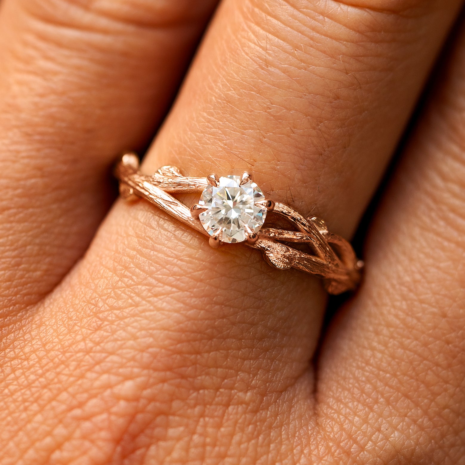 Close up view of a model's fingers wearing a 14k rose gold lab diamond Branches Ring