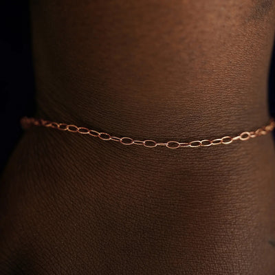 A model's wrist wearing a solid rose gold Veren Bracelet